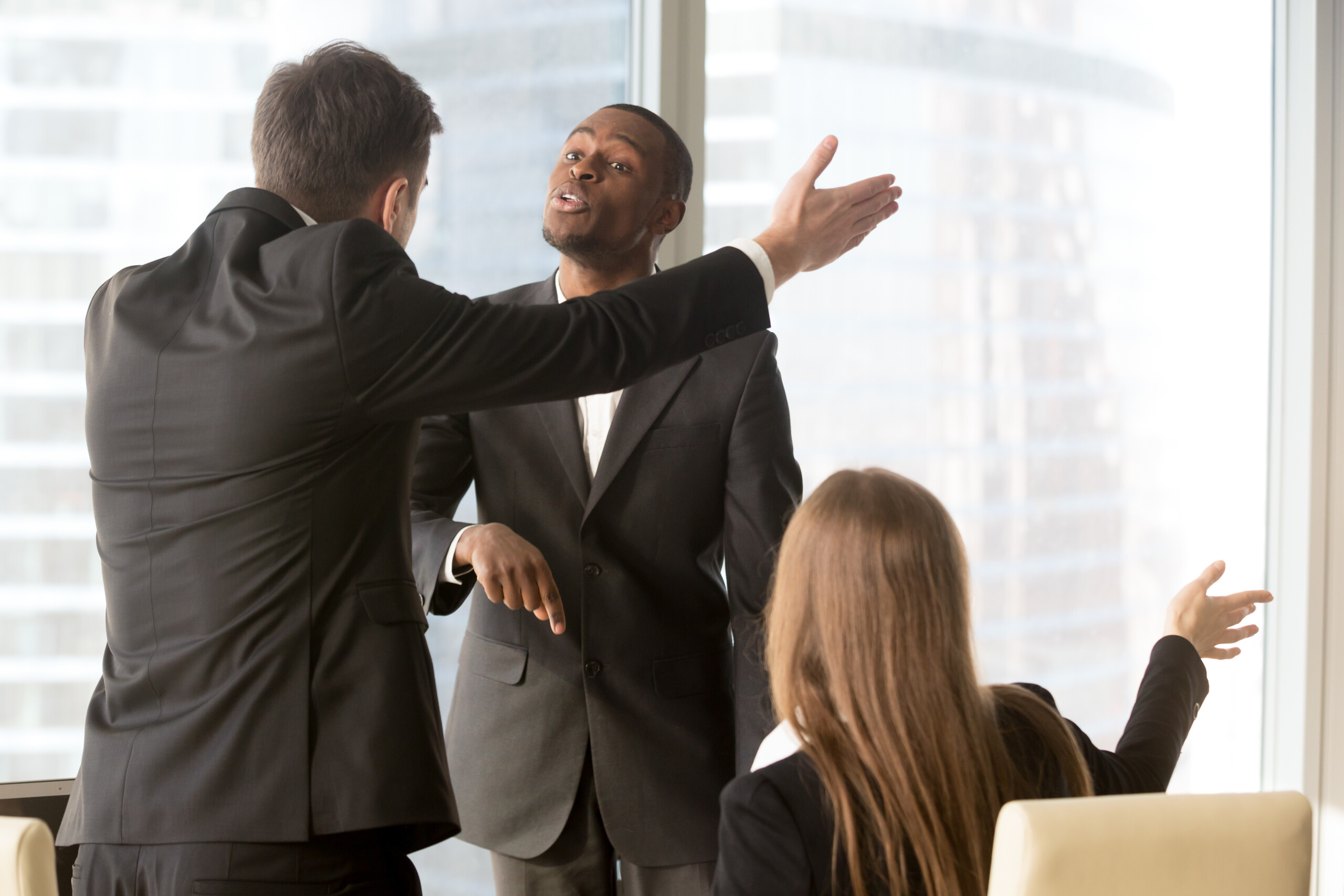 Annoyed business partners arguing during meeting